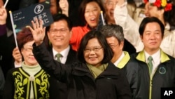 Taiwan's Democratic Progressive Party, DPP, presidential candidate, Tsai Ing-wen, raises her hands as she declares victory in the presidential election Saturday, Jan. 16, 2016, in Taipei, Taiwan.