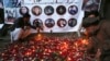 FILE - Afghan residents light candles to pay tribute to Afghan journalists killed in a suicide attack in Kabul, Afghanistan, May 3, 2018. Two Islamic State suicide bombers struck in Afghanistan's capital, killing 25 people, including nine journalists who had rushed to the scene.