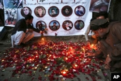 FILE - Afghan residents light candles to pay tribute to Afghan journalists killed in a suicide attack in Kabul, Afghanistan, May 3, 2018.