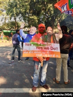 Party workers held up placards of Modi, who led the campaign in Gujarat, Dec. 18, 2017.