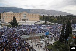 Protesters wave Greek flags outside parliament in Athens, Jan. 20, 2019. Greek lawmakers are to vote this coming week on whether to ratify the agreement that will rename its northern neighbor Republic of North Macedonia.