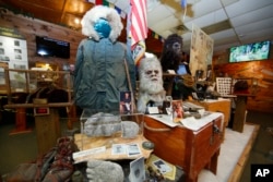 This Aug. 8, 2019, photo shows items donated by the family of Yeti researcher Tom Slick on display at Expedition: Bigfoot! The Sasquatch Museum in Cherry Log, Ga. The owner of this intriguing piece of Americana at the southern edge of the Appalachians is David Bakara, a longtime member of the Bigfoot Field Researchers Organization who served in the Navy, drove long-haul trucks and tended bar before opening the museum in early 2016 with his wife, Malinda. (AP Photo/John Bazemore)