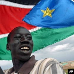 A resident of Abyei marches with the Southern Sudan flag (File)