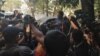 Reuters journalist Wa Lone is being taken back to jail at the end of the court session, Jan. 10, 2018, surrounded by members of the Burmese media. 