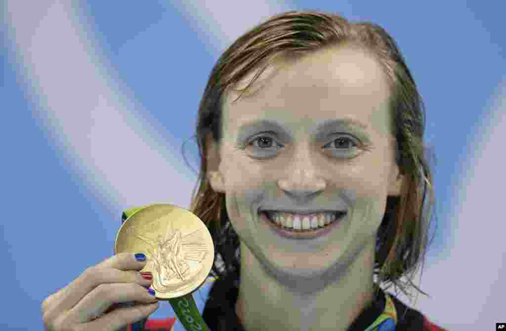 Atlet renang AS Katie Ledecky memamerkan medali emasnya setelah mencetak rekor baru dunia dalam final gaya bebas 400 meter putri pada Olimpiade 2016 di Rio de Janeiro, Brazil (8/8).&nbsp;(AP/Michael Sohn)