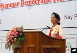 FILE - Myanmar's State Counsellor Aung San Suu Kyi delivers an opening speech during the Forum on Myanmar Democratic Transition at Myanmar International Convention Center in Naypyitaw, Myanmar, Aug 11, 2017.