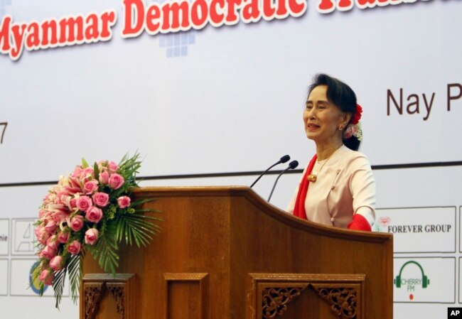 FILE - Myanmar's State Counsellor Aung San Suu Kyi delivers an opening speech during the Forum on Myanmar Democratic Transition at Myanmar International Convention Center in Naypyitaw, Myanmar, Aug 11, 2017.