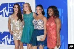 FILE - U.S. Olympic gymnasts, from left, Aly Raisman, Madison Kocian, Laurie Hernandez, and Simone Biles arrive at the MTV Video Music Awards at Madison Square Garden in New York, Aug. 28, 2016.