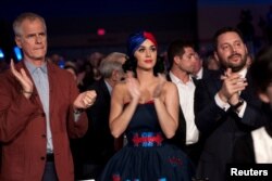 Singer Katy Perry, center, applauds as the Democratic candidates for president take the stage at the Jefferson-Jackson Dinner in Des Moines, Iowa, Oct. 24, 2015.