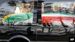 People react as the procession for former South African president Nelson Mandela leaves the military hospital in Pretoria, Dec. 11, 2013.