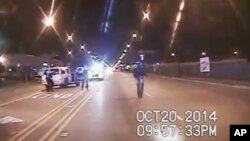 In this Oct. 20, 2014 frame from dash-cam video provided by the Chicago Police Department, Laquan McDonald walks down the street moments before being shot by police officer Jason Van Dyke. 