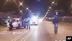 In this Oct. 20, 2014 frame from dash-cam video provided by the Chicago Police Department, Laquan McDonald walks down the street moments before being shot by police officer Jason Van Dyke.