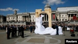 London Mayor Boris Johnson (center L) watches as a 5.5-meter (20ft) recreation of the 1,800-year-old Arch of Triumph in Palmyra, Syria, is unveiled at Trafalgar Square in London, Britain, April 19, 2016.