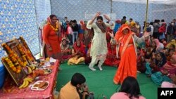 Hindu devotees take part in a religious gathering next to a community kitchen organized by Hindu right wing activists at a vacant plot where previously Muslim devotees used to hold Friday prayers in Gurgaon, New Delhi, Dec. 17, 2021. 