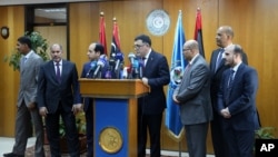 FILE - Fayez al-Saraj, flanked by members of the Presidential Council, speaks during a news conference at the Mitiga Naval Base in Tripoli, Libya, March, 30, 2016.