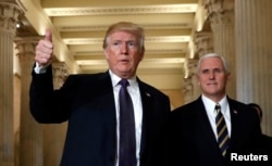 FILE - U.S. President Donald Trump gives a thumbs-up as he and Vice President Mike Pence depart the U.S. Capitol after a meeting to discuss tax legislation with House Republicans, Nov. 16, 2017.