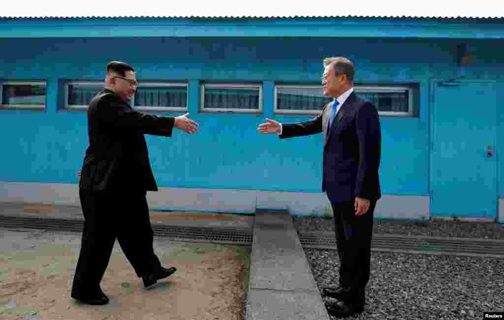 South Korean President Moon Jae-in and North Korean leader Kim Jong Un shake hands at the truce village of Panmunjom inside the demilitarized zone separating the two Koreas, South Korea.