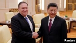 U.S. Secretary of State Mike Pompeo shakes hands with Chinese President Xi Jinping at the Great Hall of the People in Beijing, June 14, 2018. Pompeo raised the trade issue directly with Xi Thursday.