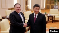 U.S. Secretary of State Mike Pompeo shakes hands with Chinese President Xi Jinping at the Great Hall of the People in Beijing, June 14, 2018. 