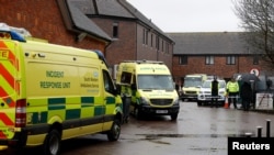 Emergency services vehicles are parked behind a pub that was visited by former Russian intelligence officer Sergei Skripal and his daughter Yulia before they found poisoned; and which remains closed; in Salisbury, Britain, March 28, 2018. 