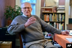 Rainer Weiss, one of three awarded this year's Nobel prize in physics, poses for a photograph at his home in Newton, Mass., Oct. 3, 2017.