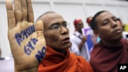  A Buddhist monk shows a message written in his palm to protest against the ethnic minority Rohingyas in Burma during a visit of Burma's President Thein Sein in Bangkok, Thailand, July 24, 2012.