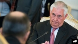 U.S. Secretary of State Rex Tillerson listens, right, to Russian Foreign Minister Sergey Lavrov, back to a camera, during their meeting in Moscow, April 12, 2017. 