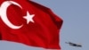 FILE - A Turkish Air Force F16 jet fighter takes off from an air base as Turkey's national flag is seen in the foreground, April 28, 2010. A top official of Turkey's state-run arms company was arrested this week for allegedly trying to sell weapons secrets.