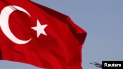 A Turkish Air Force F16 jet fighter takes off from an air base as Turkey's national flag