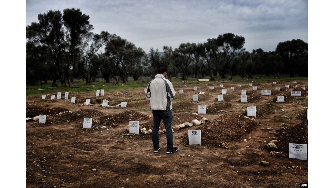 A man looks at a graveyard in Mytilene, Greece, Feb. 17, 2016, for refugees and migrants who drowned in their attempt to cross the Aegean sea from Turkey to the island of Lesbos.