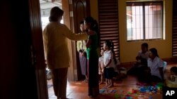 In this file photo, U.S. Secretary of State Hillary Clinton visits AFSEIP, a rehabilitation center for sex trafficking victims, Oct. 31, 2010 in Siem Reap, Cambodia. (AP Photo/Evan Vucci, Pool)