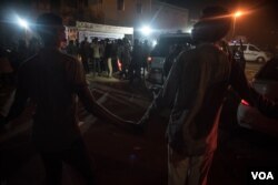 Protesters hold hands to create a cordon to create space for ambulances and other vehicles transporting wounded to hospital. (J. Patinkin for VOA)