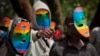 FILE - Kenya gay and lesbian activists conceal their identity behind masks to protest a wave of laws against homosexuality in African countries, Feb. 10, 2014. 