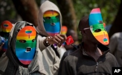FILE - Kenya gay and lesbian activists conceal their identity behind masks to protest a wave of laws against homosexuality in African countries, Feb. 10, 2014.