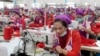 FILE: Garment workers sew clothes in a factory as they wait for visit by Prime Minister Hun Sen outside of Phnom Penh, Cambodia, Wednesday, Aug. 30, 2017. (AP Photo/Heng Sinith)