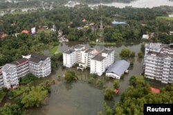 FILE - An aerial view shows partially submerged buildings at a flooded area in the southern state of Kerala, India, Aug. 19, 2018.