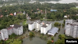 An aerial view shows partially submerged buildings at a flooded area in the southern state of Kerala, India, Aug. 19, 2018.