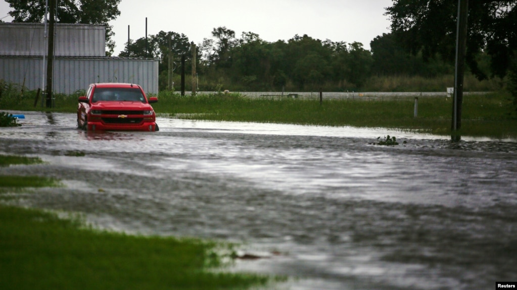 A car near Vermilion Bay is seen partially submerged in waters brought by Hurricane Laura approaching Abbeville, Louisiana, U.S., August 26, 2020. REUTERS/Kathleen Flynn REFILE