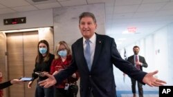 Sen. Joe Manchin, D-W.Va., leaves his office moments after speaking with President Joe Biden about his long-stalled domestic agenda, at the Capitol in Washington, Dec. 13, 2021. 