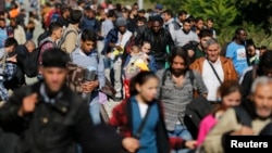 FILE - Migrants disembark from a train after arriving at the station in Botovo, Croatia Sept. 23, 2015. Norway's center-right government on Tuesday proposed tightening the country's asylum rules to avoid what the immigration minister described as "violent consequences" for the country's welfare system.
