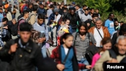 Migrants disembark from a train after arriving at the station in Botovo, Croatia, Sept. 23, 2015, before walking to the Hungarian border.