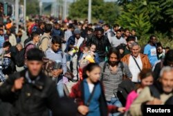 Migrants disembark from a train after arriving at the station in Botovo, Croatia, Sept. 23, 2015, before walking to the Hungarian border.