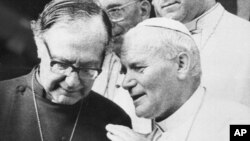 Pope John Paul II meets with the Archbishop of Canterbury Robert Runcie, left, head of the Anglican Church, in Accra, Ghana, May 9, 1980.