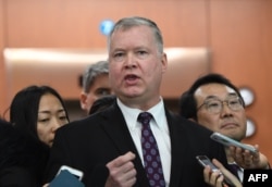 U.S. special representative on North Korea Stephen Biegun, center, speaks to reporters as his South Korean counterpart Lee Do-hoon, right, looks on.