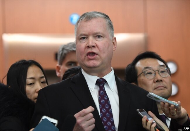U.S. special representative on North Korea Stephen Biegun, center, speaks to reporters as his South Korean counterpart Lee Do-hoon, right, looks on.