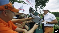 Phil Mickelson signs autographs after a practice round for the U.S. Open Championship golf tournament at Congressional Country Club in Bethesda, Maryland, June 14, 2011