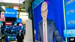 FILE - Federal Reserve Chairman Jerome Powell appears on a television screen on the floor of the New York Stock Exchange, Nov. 3, 2021. 