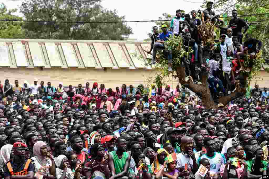 Senegalese supporters watch the Russia 2018 World Cup Group H football match between Senegal and Colombia on a giant screen at a fan zone in Dakar.