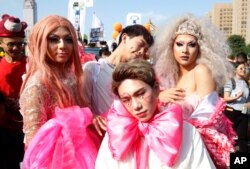 FILE - Costumed participants pose on a street during the annual gay and lesbian parade, organized by Taiwan LGBT Pride, in Taipei, Taiwan, Oct. 27, 2018.