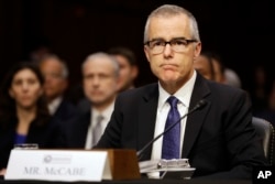 FILE - Former Acting FBI Director Andrew McCabe listens on Capitol Hill in Washington, May 11, 2017, while testifying before a Senate Intelligence Committee hearing on major threats facing the U.S.
